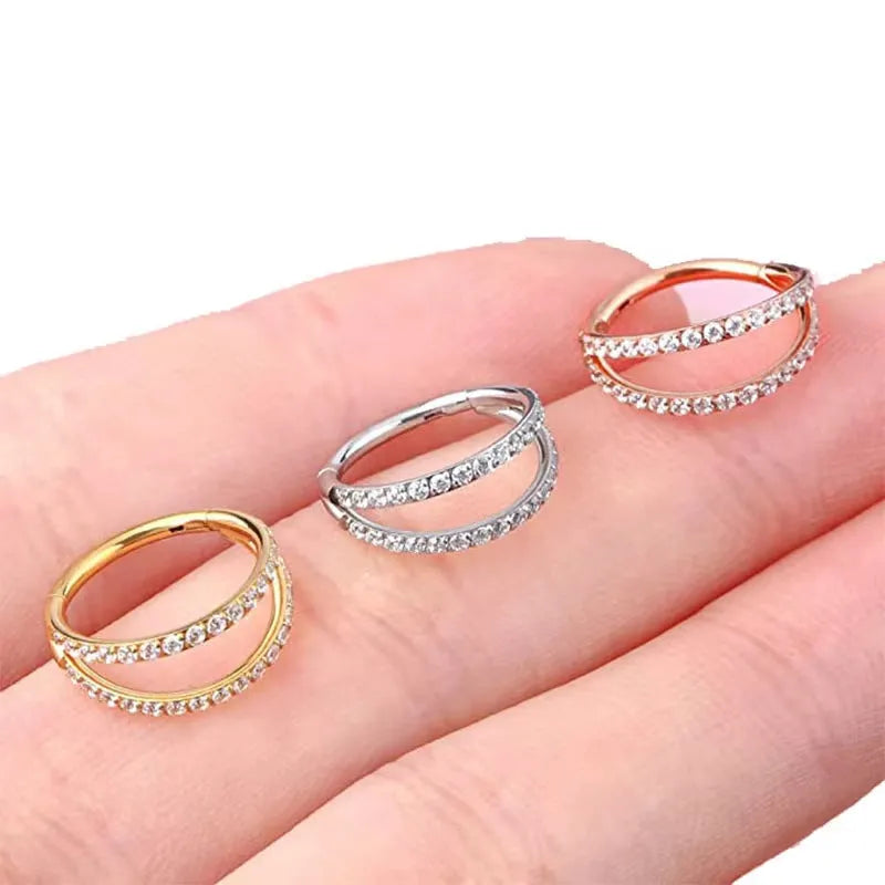 G23 titanium alloy lip and nose ring body jewellery in gold and steel colour finishes, showing different gauge sizes.