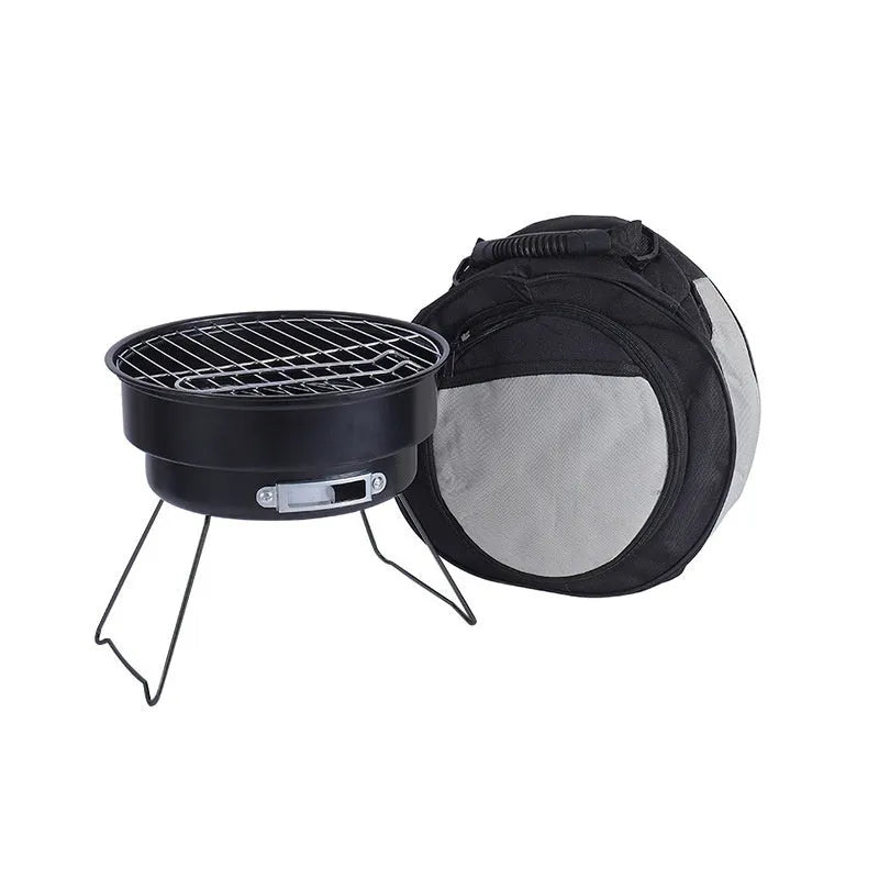 Small round folding barbecue stove with grill mesh, leg, and charcoal clip on a grey background.