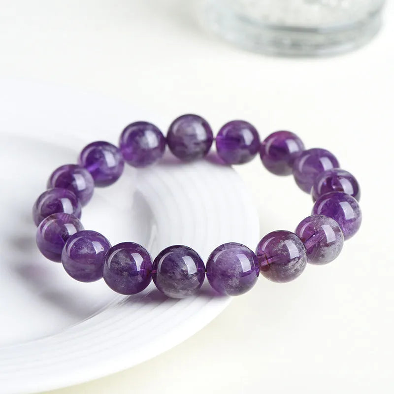 Snow mountain purple feather amethyst crystal bracelet with scattered beads and Ruyi pattern on a wrist.
