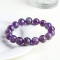 Snow mountain purple feather amethyst crystal bracelet with scattered beads and Ruyi pattern on a wrist.