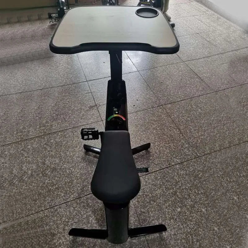 Black upright magnetic control exercise bike with table for small household fitness and home cycling workouts