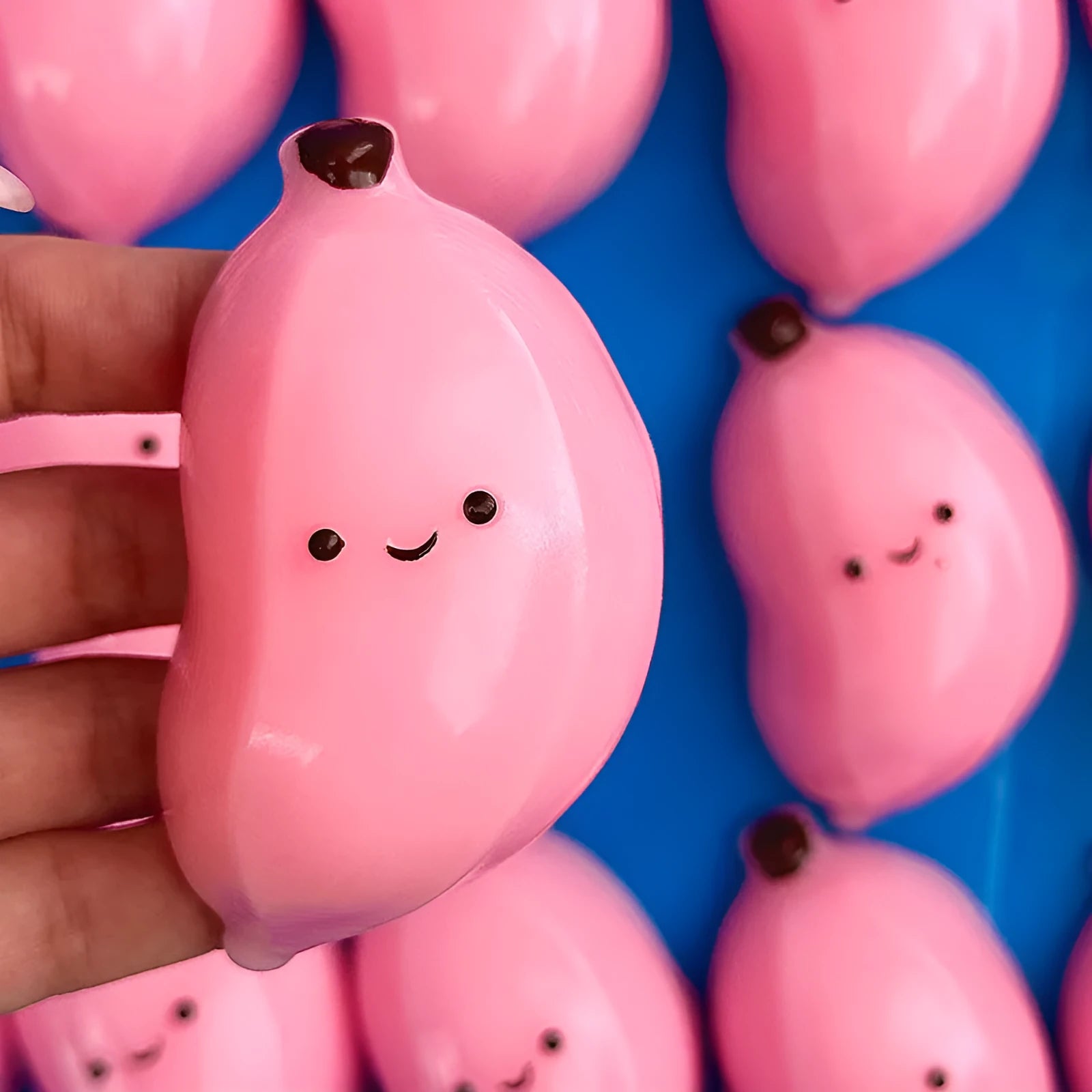 Chubby Banana Squeezing Toy in pink and green TPR material for stress relief