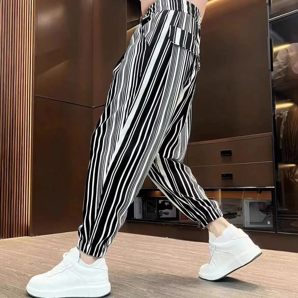 Men's cropped ankle-tied ice silk pants in dark gray stripe pattern, front view on model