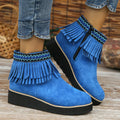 Women's suede ankle boots with a wedge heel, side zipper, and tassel detail in dark brown.