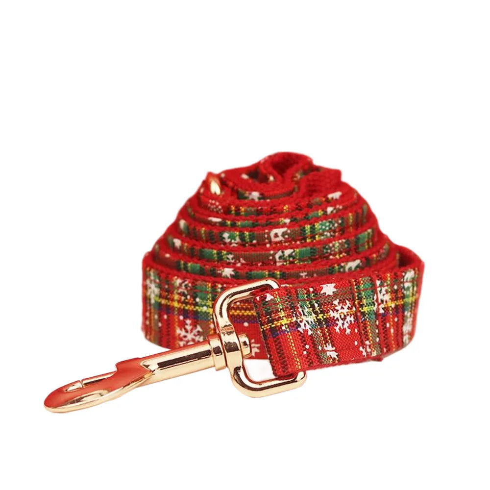 Red snowflake Christmas dog collar and leash set with plaid design and decorative bow on dog vest