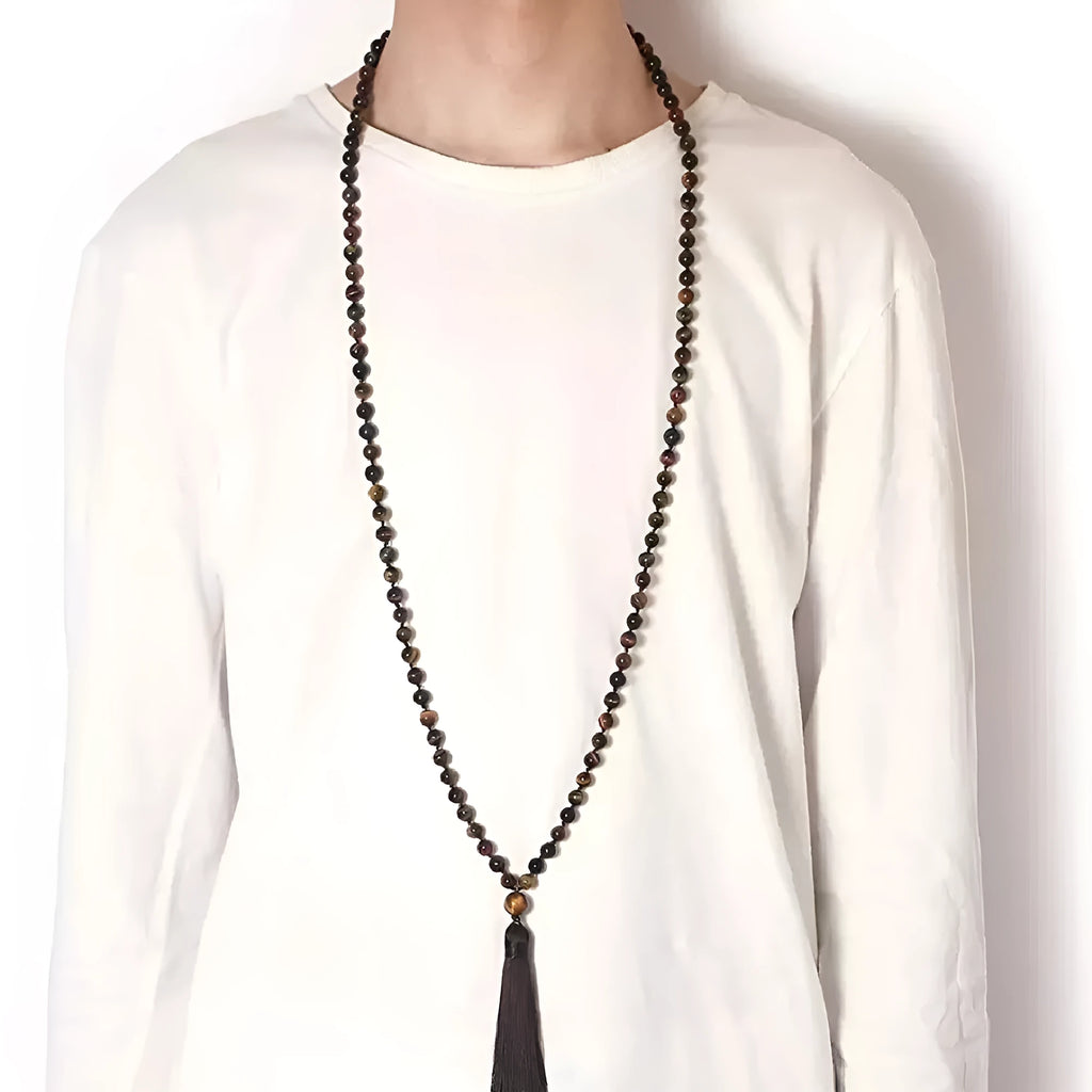 Long geometric agate tassel necklace with multi-coloured stones on a white background.
