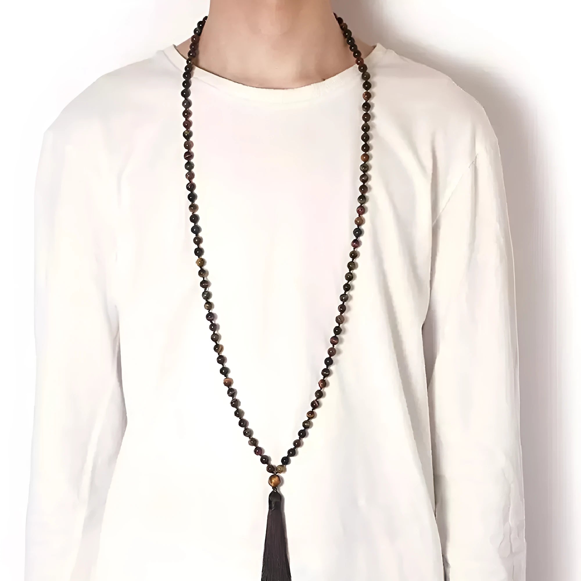 Long geometric agate tassel necklace with multi-coloured stones on a white background.