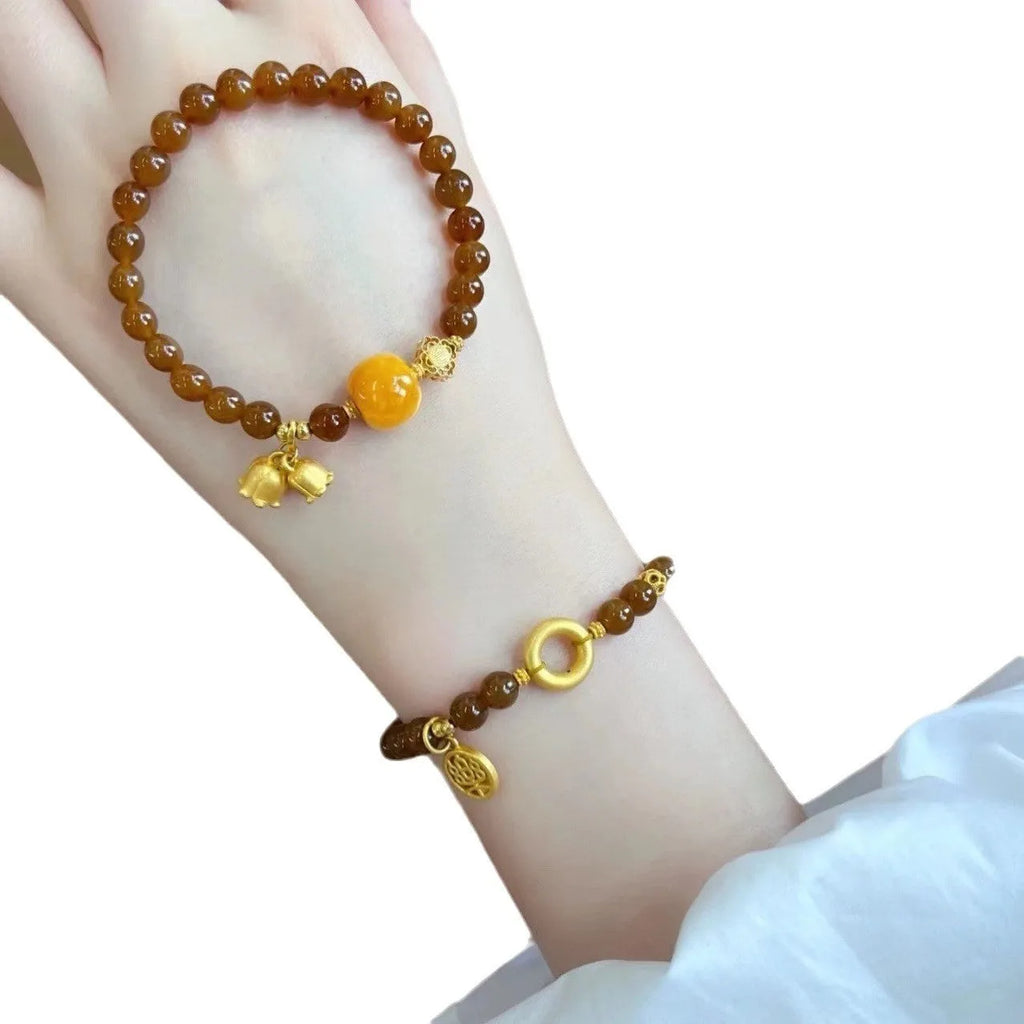 Women's caramel beeswax Lily charm bracelet with electroplated finish and New Chinese style design.