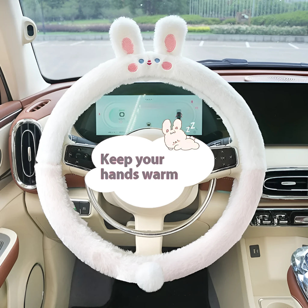 Plush rabbit fur style steering wheel cover with embroidered panda design, fitted on a car wheel