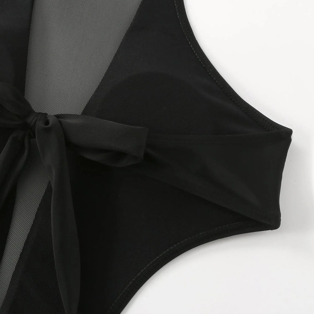 Black one-piece swimsuit with nude back design and hollow-out detailing on female model