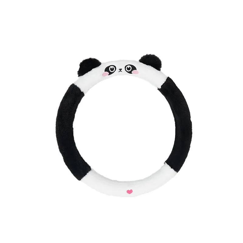 Plush rabbit fur style steering wheel cover with embroidered panda design, fitted on a car wheel