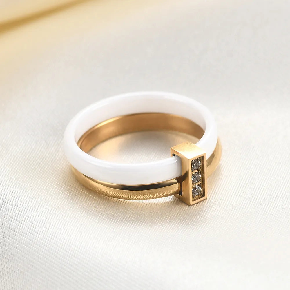 Glossy black geometric ceramic ring with a 6mm wide band on a woman's finger.