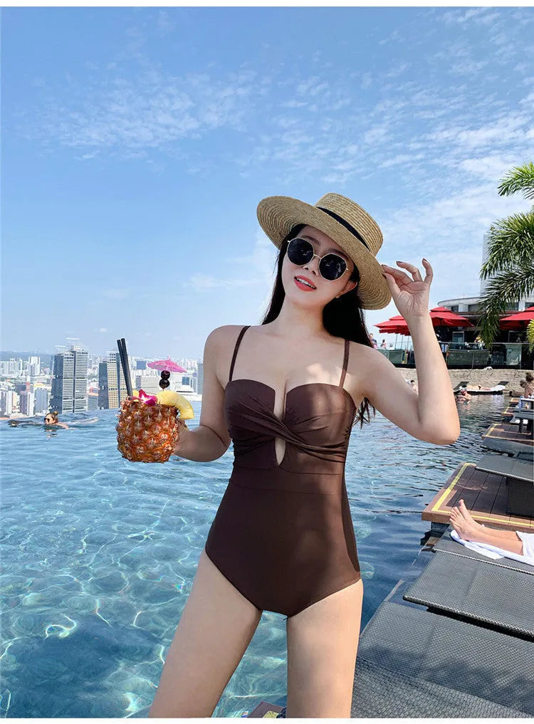 A solid colour one-piece swimsuit for women with spaghetti straps, shown in white.