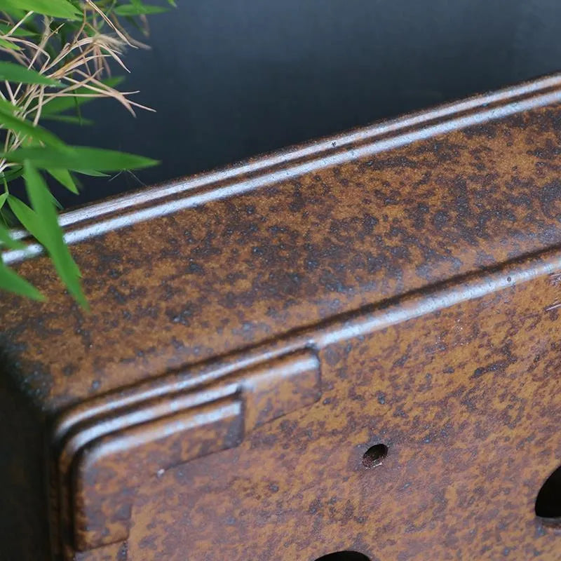 Rectangular purple sand bonsai pot with rustic firewood-burned texture, shown empty on a wooden surface.