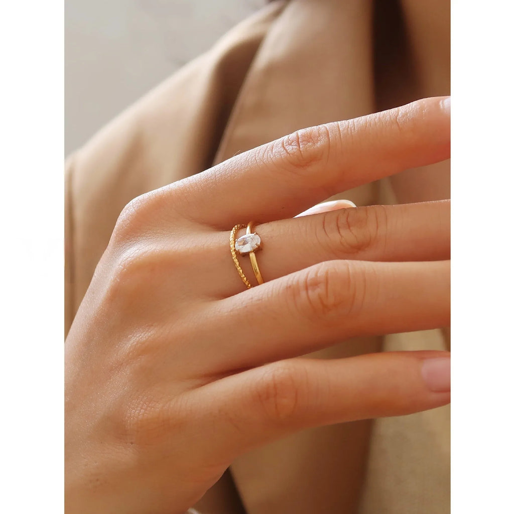 Golden heart-shaped stainless steel ring with electroplated finish shown in UK sizes 5-8