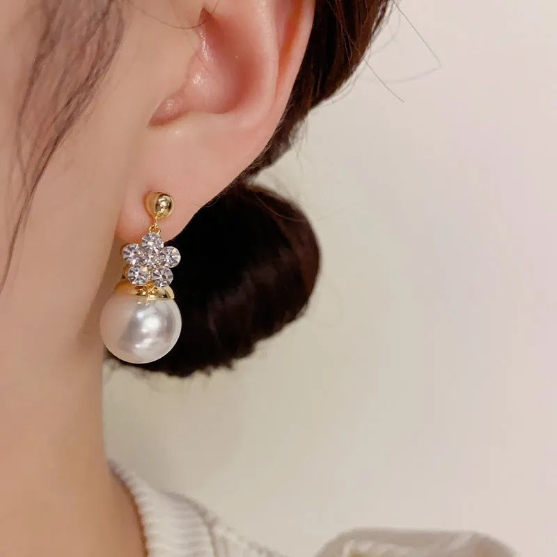 Female Korean style double-sided flower pearl earrings in gold plated copper with clip-on design