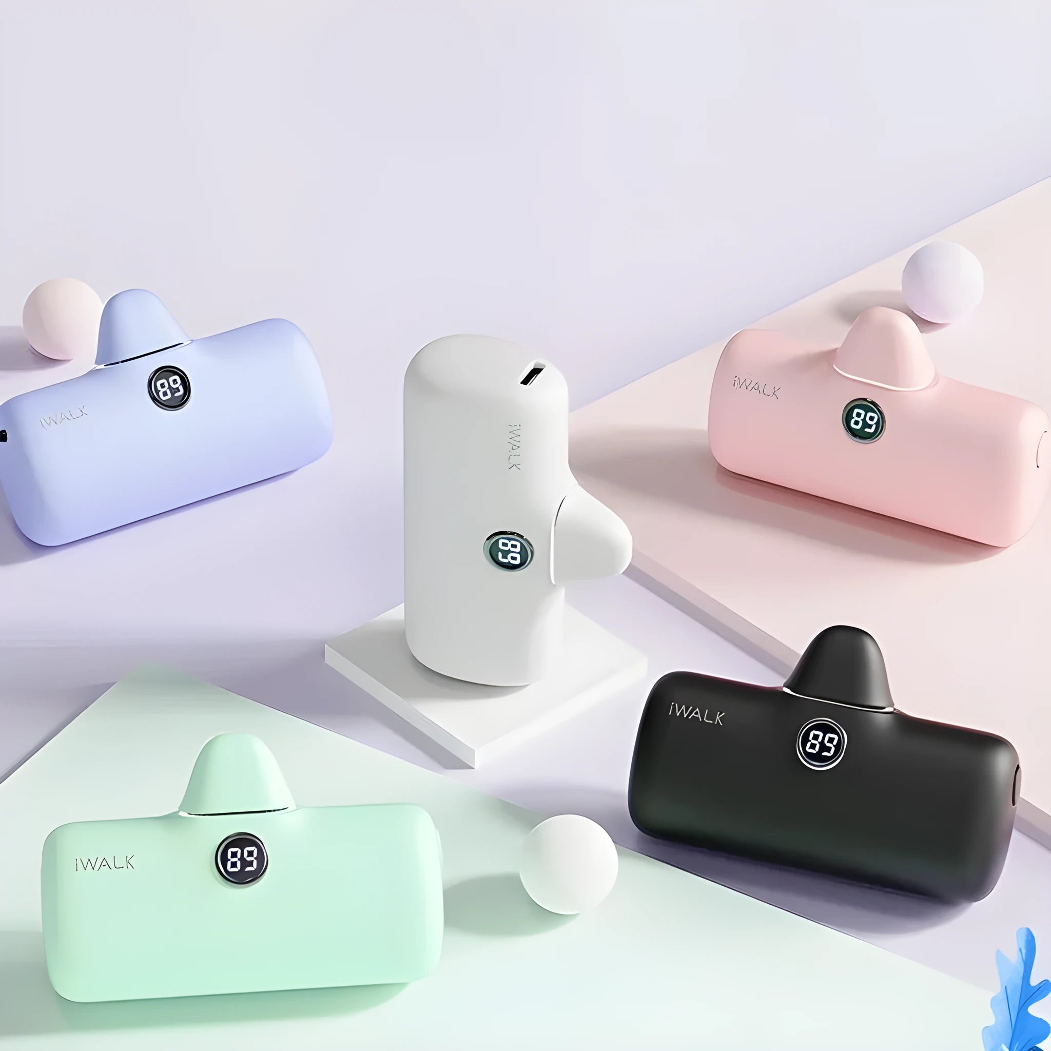 Compact cylindrical lipstick power bank in purple showing digital battery percentage display on one end.
