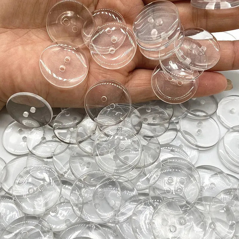 Transparent two-eye resin button 10mm on white background