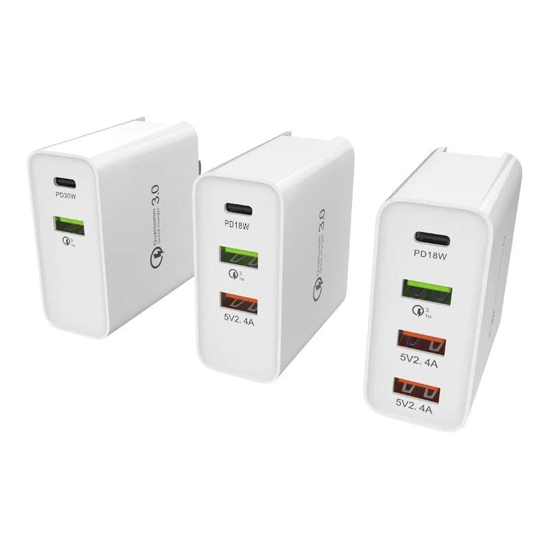 White multi-port USB fast charger with PD and QC support plugged into a wall socket.
