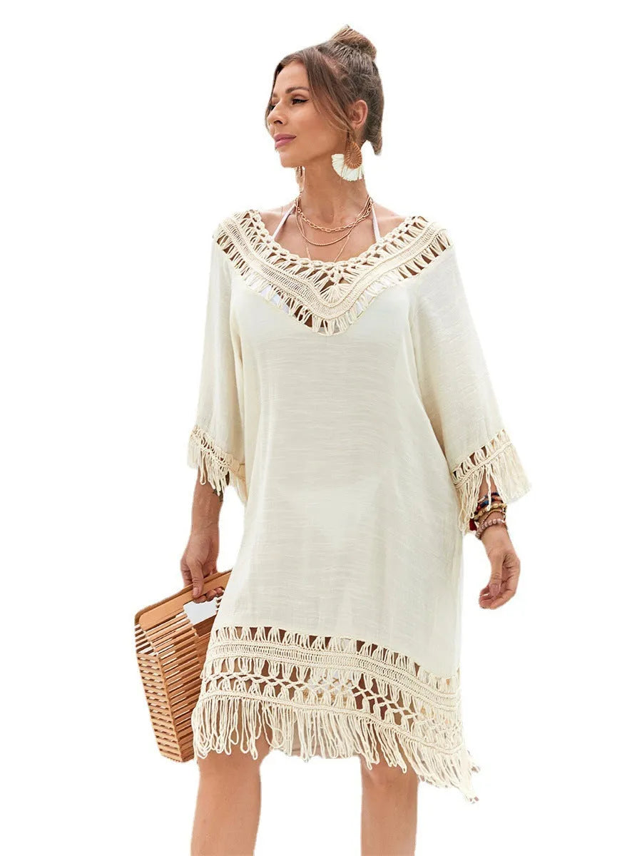 Apricot hand-crocheted women's beach dress on a hanger.