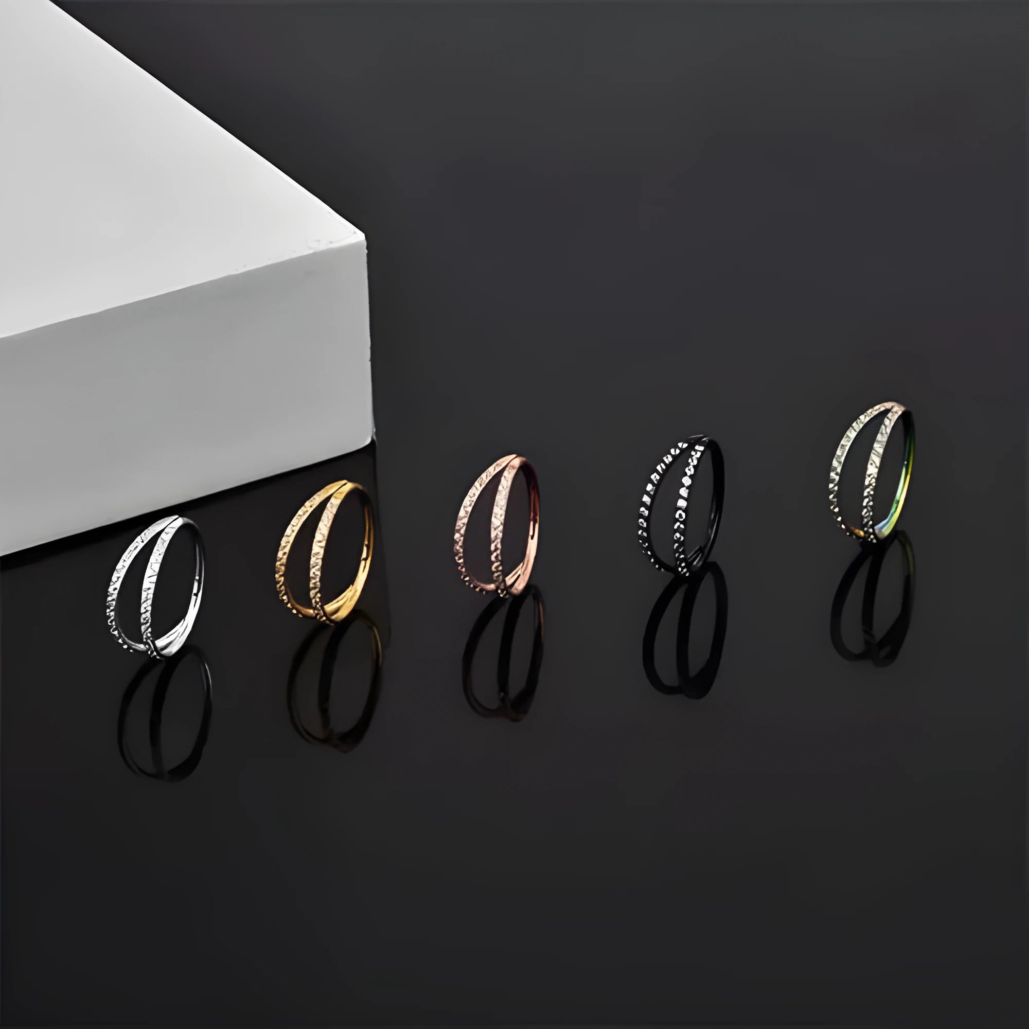G23 titanium alloy lip and nose ring body jewellery in gold and steel colour finishes, showing different gauge sizes.
