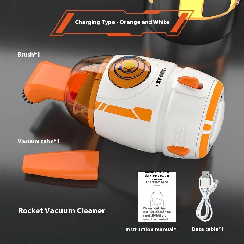 Blue rocket-shaped USB rechargeable handheld desktop vacuum cleaner on a wooden desk next to a keyboard