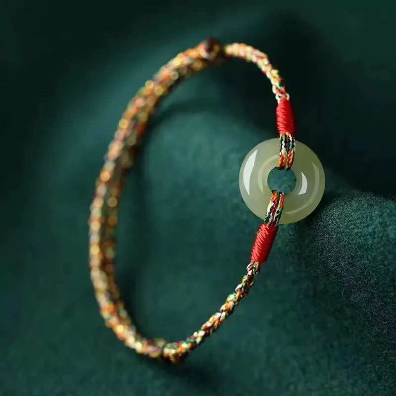 Colourful braided rope bracelet with peace buckle closure showing woven texture