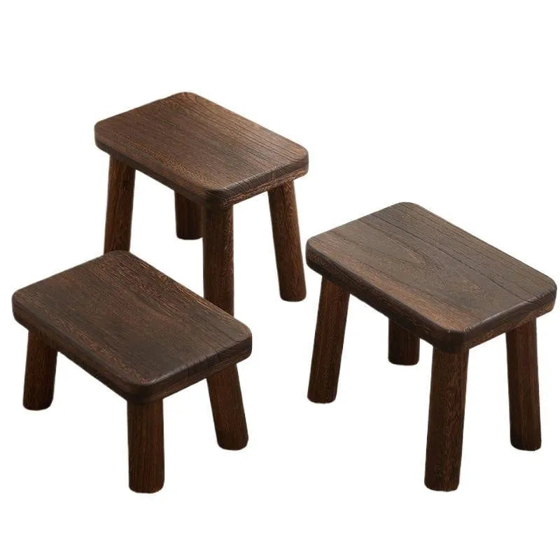 Distressed solid wood stool for changing shoes with a bracket frame structure.