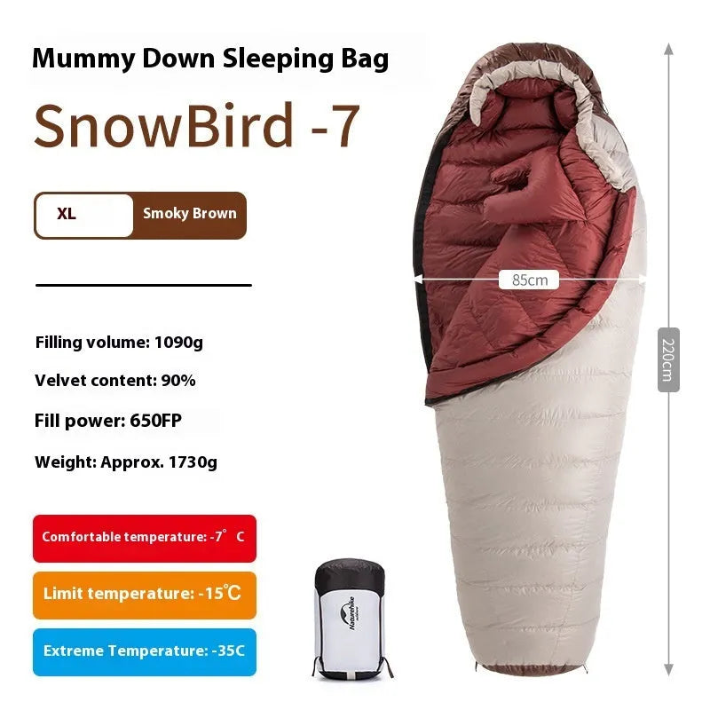 Adult mummy-style sleeping bag with goose down filling shown with its storage bag.