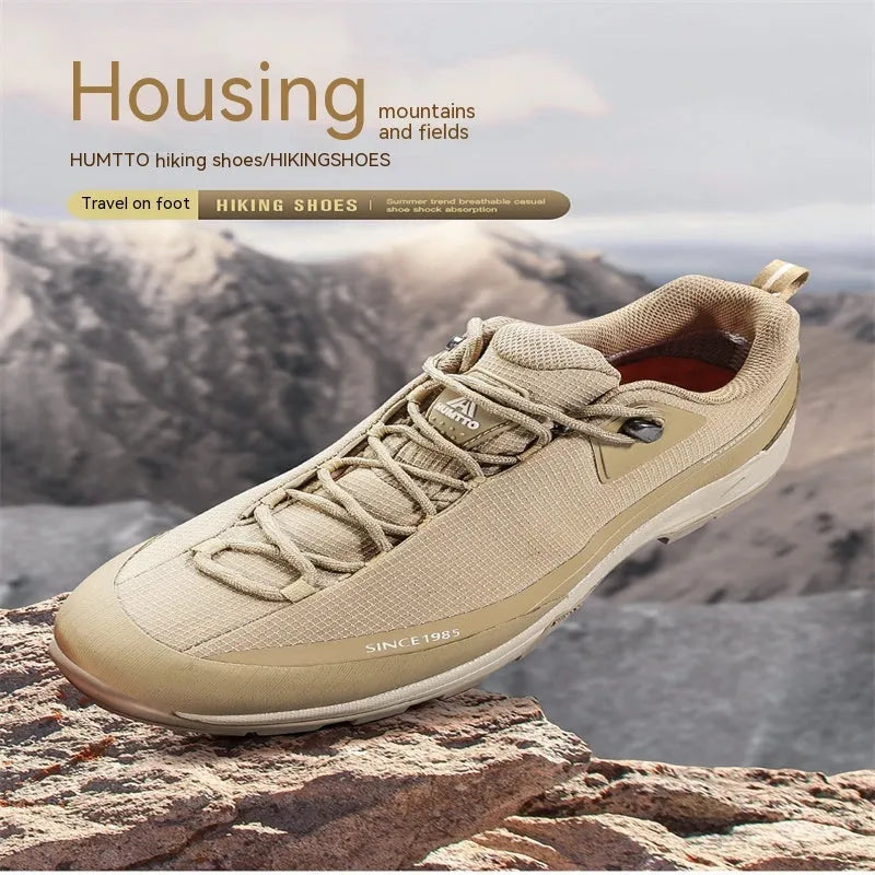 Men's low-top mountain climbing hiking boots in black with lace-up front and non-slip rubber sole.