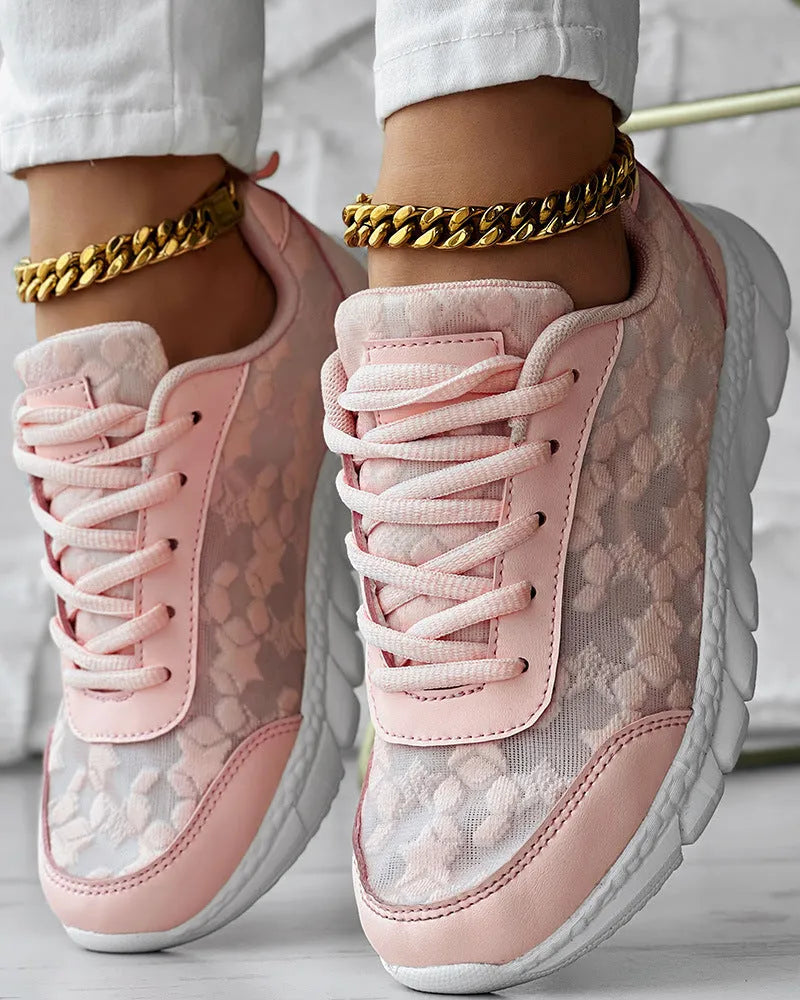Women's white canvas casual running shoes with flat sole on a light background.