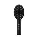 KD3802 Black handheld scalp massage device with charging cable on white background