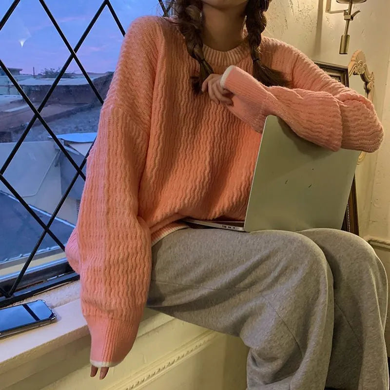 A lake blue women's loose-fit pullover sweater with long sleeves on a hanger.
