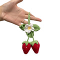 Handwoven strawberry-shaped car pendant made from cotton and hemp fibres.