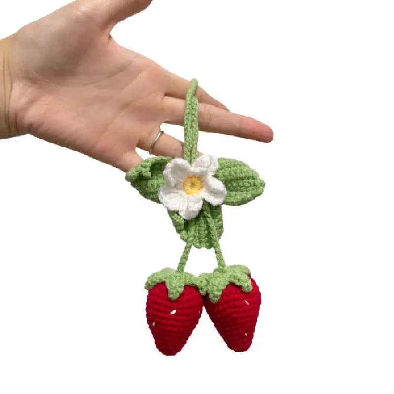 Handwoven strawberry-shaped car pendant made from cotton and hemp fibres.