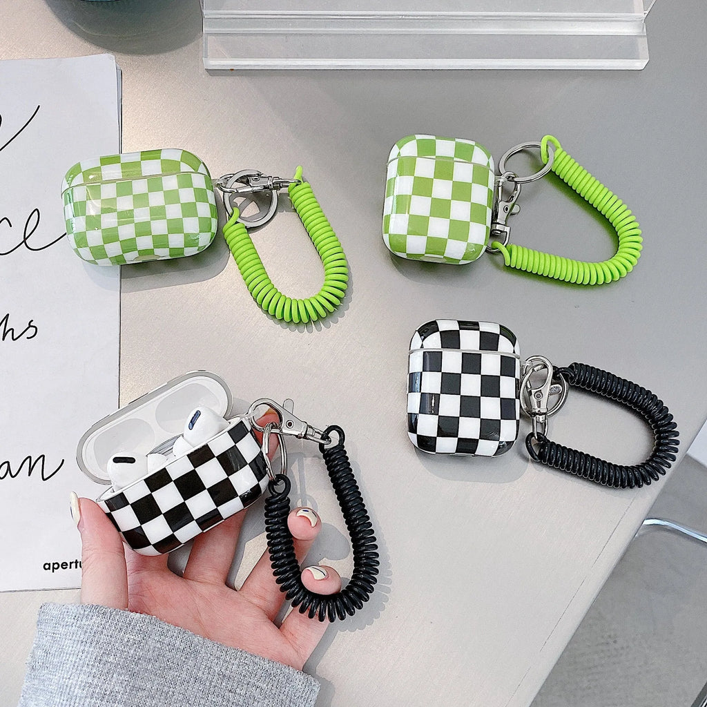 Black and green checkerboard pattern TPU protective cases for Apple AirPods with lanyard and loop pendant options.