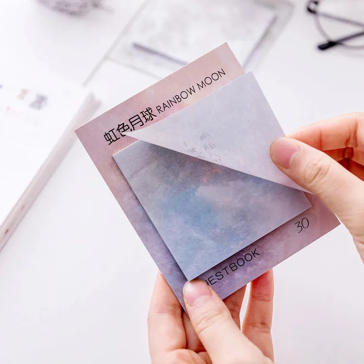Square planet-themed sticky note pad showing oil painting designs of moon, earth, and mars.
