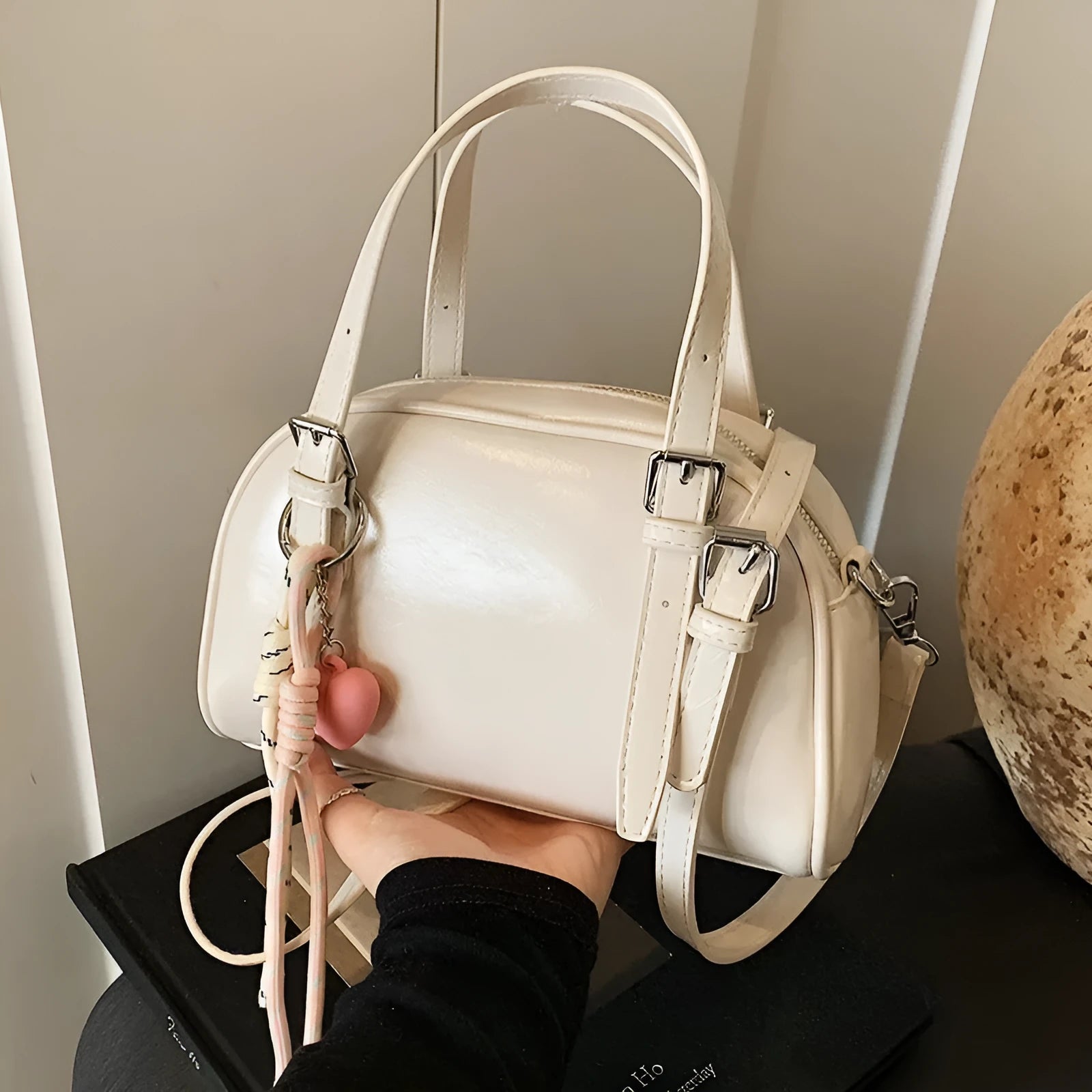 Soft PU women's shoulder bag in shell shape with sandwich pocket, shown in black with pendant strap.