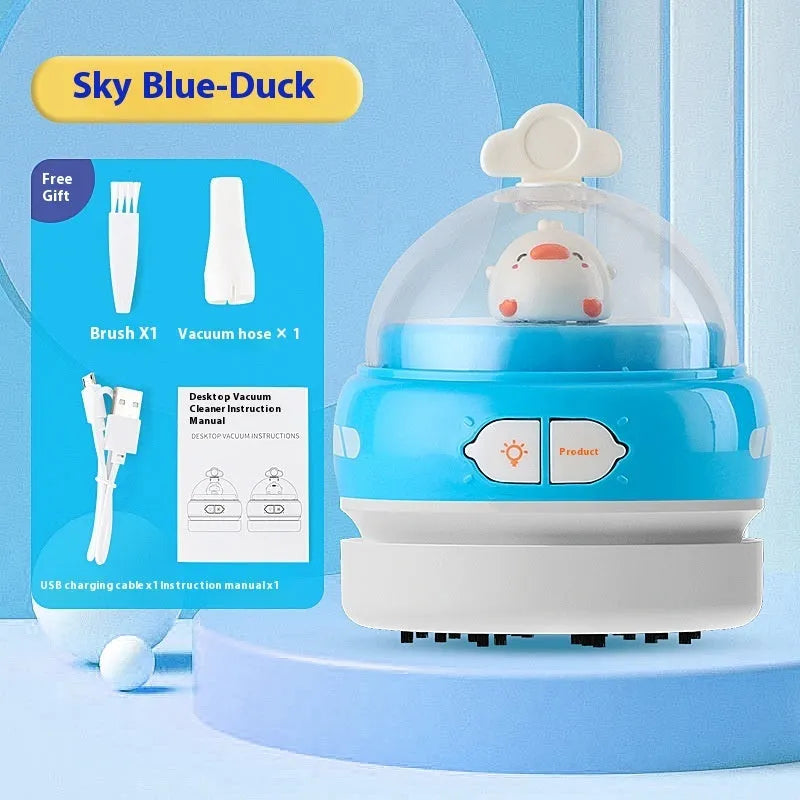 Blue rocket-shaped USB rechargeable handheld desktop vacuum cleaner on a wooden desk next to a keyboard
