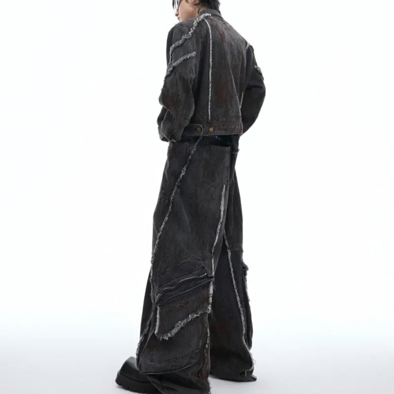 Distressed black gradient denim coat with padded shoulders and matching trousers laid flat