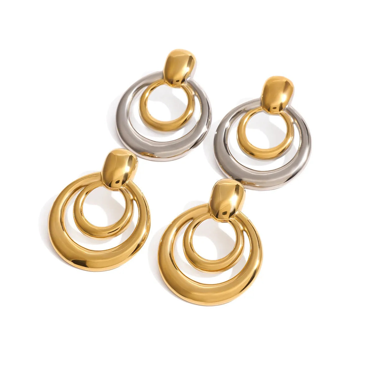 Round golden double layer hollow stud earrings with a geometric design on a white background.
