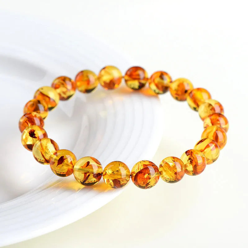 A natural yellow piebald amber bracelet with geometric beads for water purification.