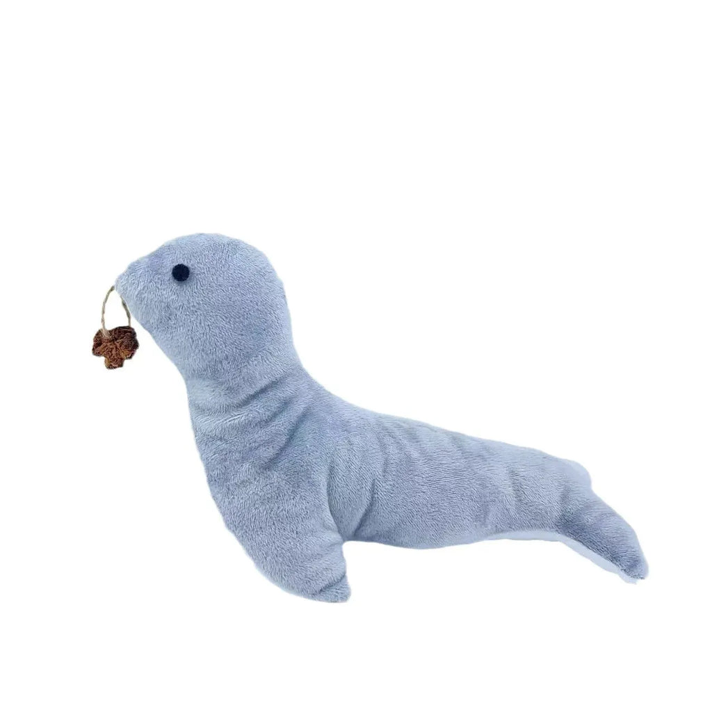 Blue sea lion plush cat toy with detailed stitching, shown alongside catnip filling and bell component