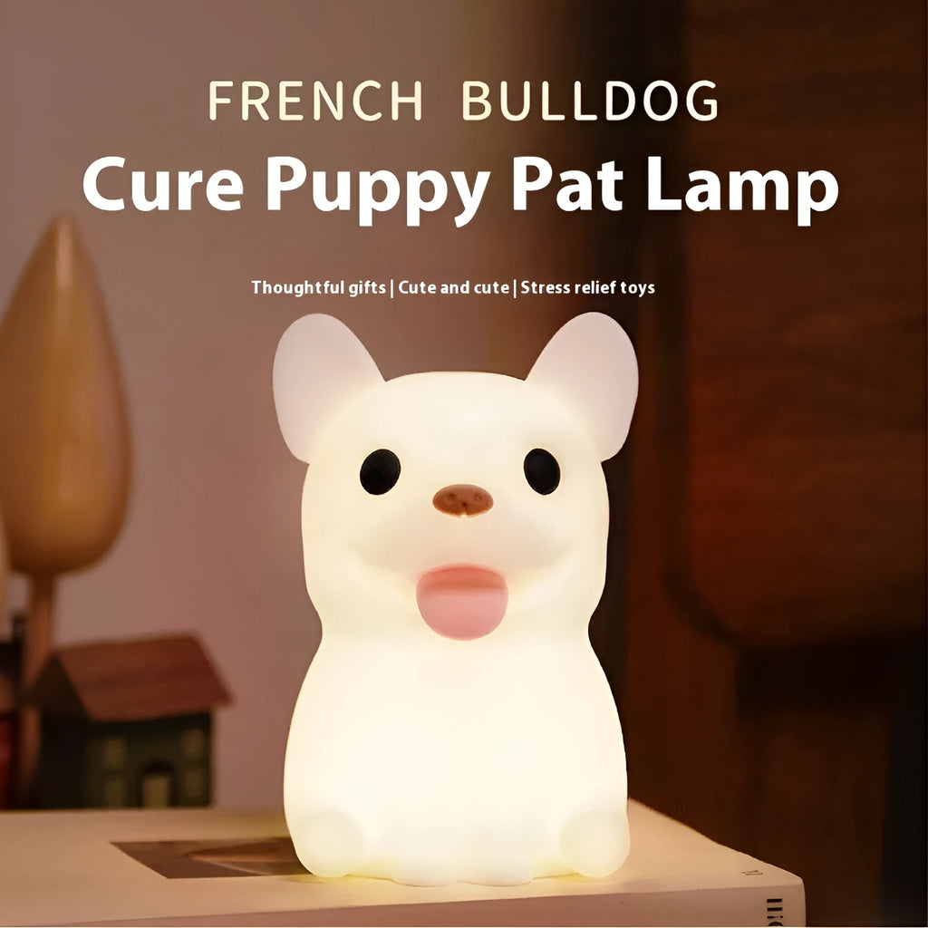 A cartoon bull-shaped silicone USB night light with a dimming function on a bedside table.