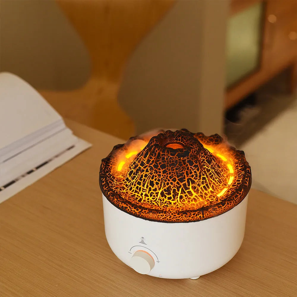 White simulated flame volcano humidifier and aroma diffuser with remote control on wooden surface