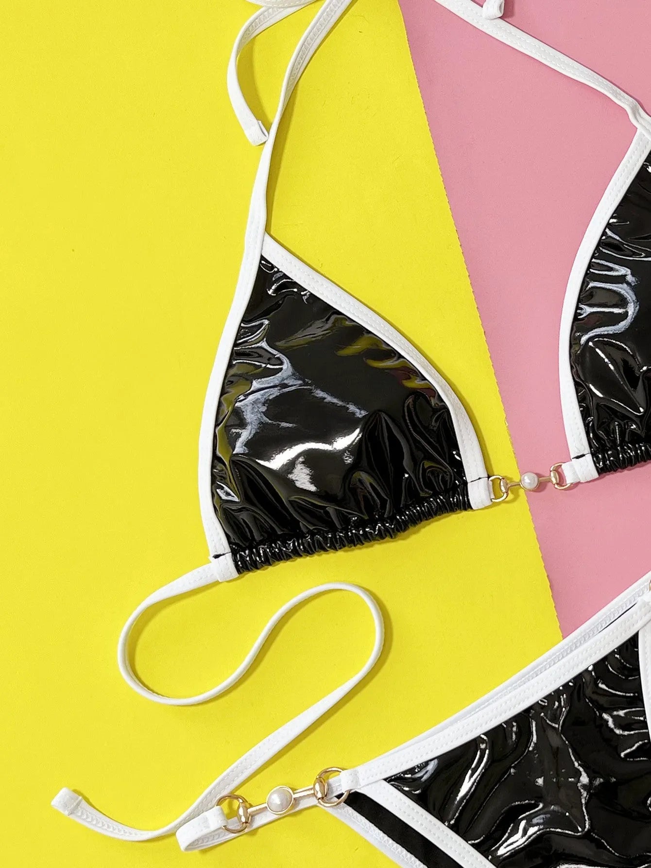 Solid black women's bikini swimsuit with triangle top and briefs style bottoms