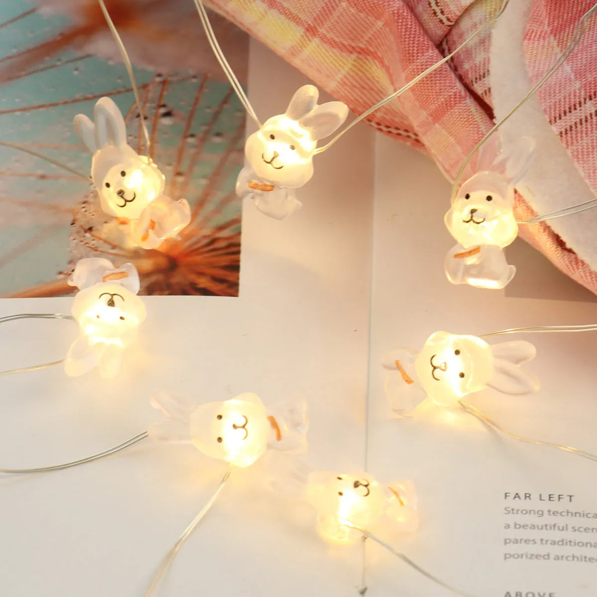 Easter LED bunny string lights with carrot and white rabbit bulbs on a dark background