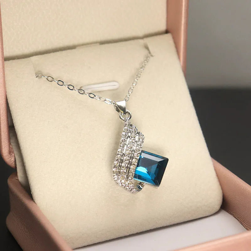 Women's electroplated alloy and glass jewellery set showing necklace with cross chain design and matching ear studs