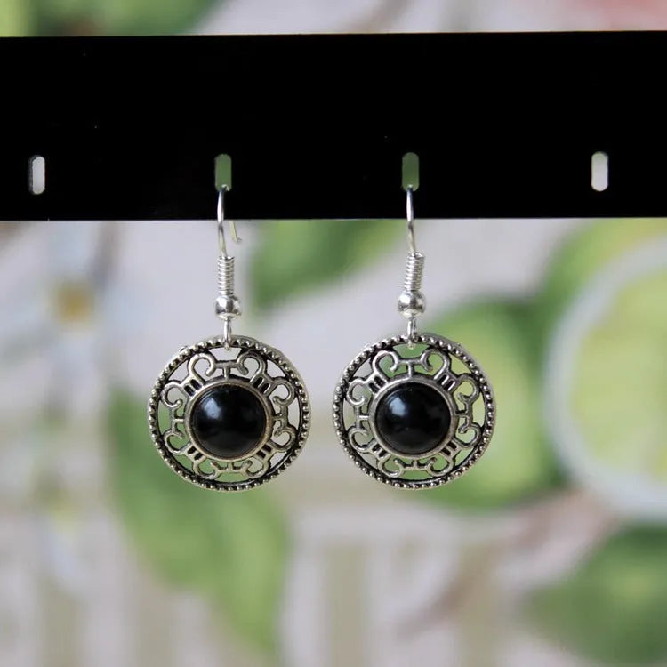 Handmade Miao silver and turquoise geometric flower disk earrings with totem patterns.