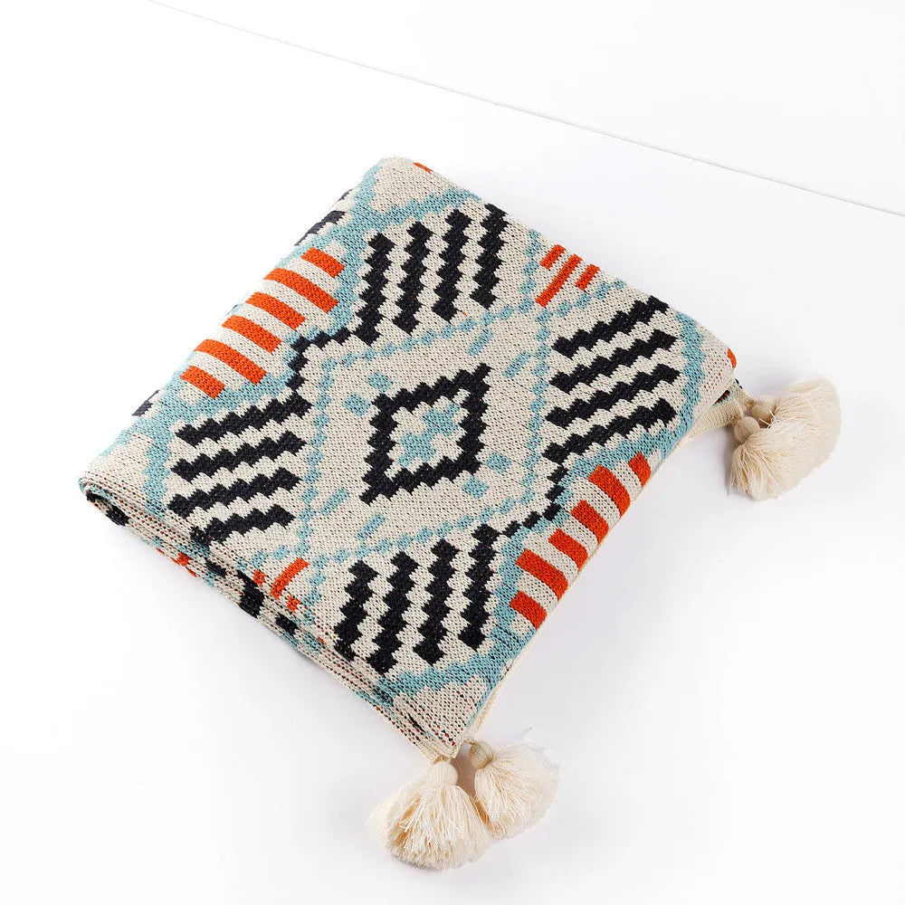 Bohemian-style acrylic knit sofa blanket with tassels in a geometric pattern